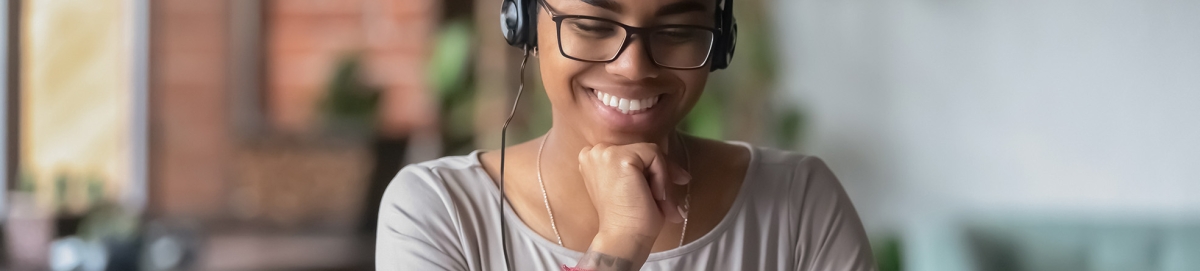 Black female student participating in webinar.