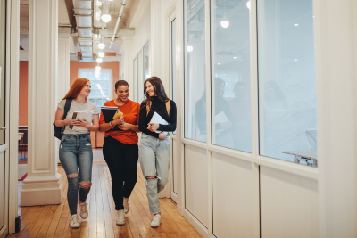 Group of female students talking and smiling.