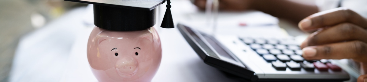 Student using calculator next to piggy bank