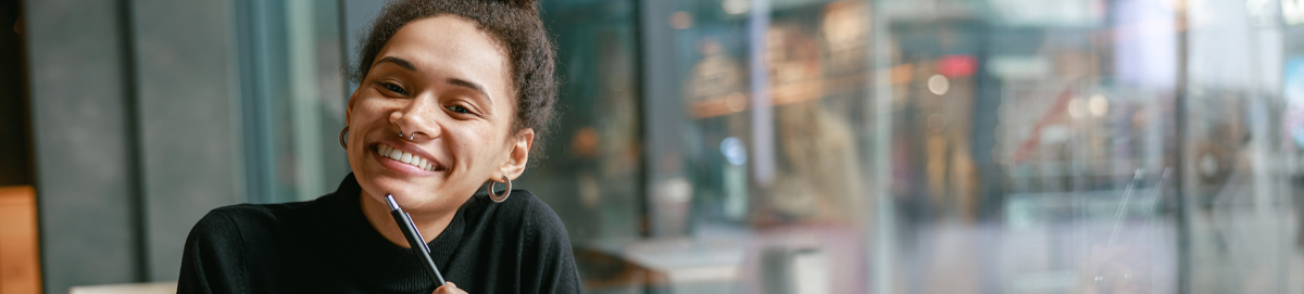 Photo of smiling woman in college campus.
