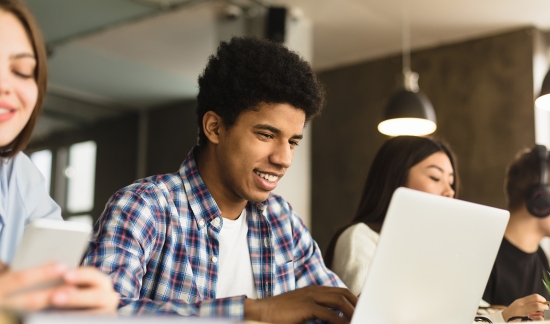 High school students workign on their laptops