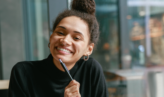 Photo of smiling woman in college campus.