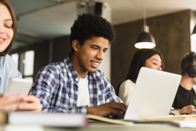 High school students workign on their laptops